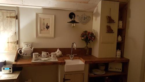 a kitchen with a sink and a counter top at The Shepherds Snug in Faversham