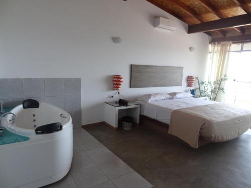 a bedroom with a bed and a bath tub at Akas Hotel Apartamentos in Canoas De Punta Sal