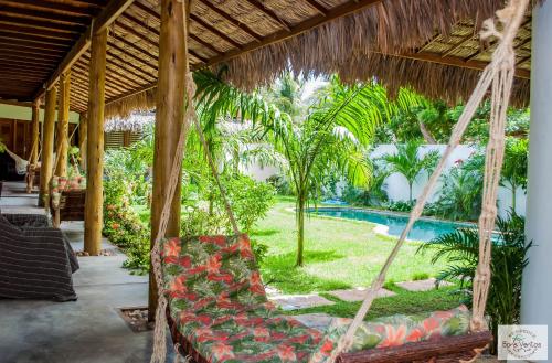 a hammock in a resort with a swimming pool at Residence Bons Ventos Jeri in Jericoacoara