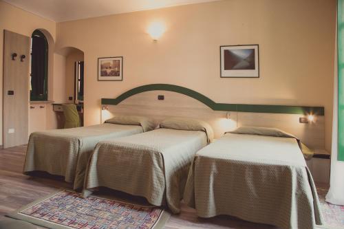Postel nebo postele na pokoji v ubytování Hotel Rainero