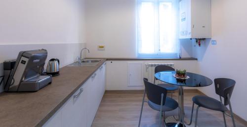 a kitchen with a small table and chairs in it at A&G Affittacamere in La Spezia