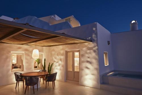 a dining room with a table and chairs on a house at Astra Suites in Imerovigli