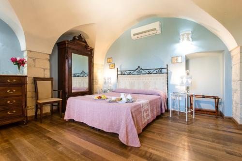 a bedroom with a bed and a table with fruit on it at Hotel Villa Gli Asfodeli in Tresnuraghes