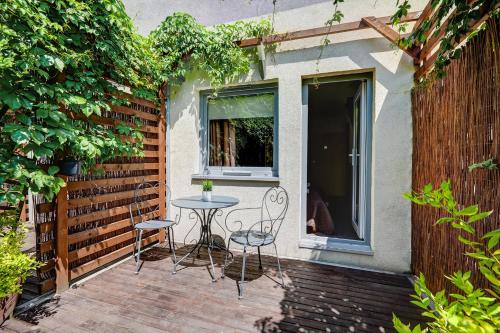 a patio with a table and chairs and a window at Smart2Stay Magnolia in Warsaw