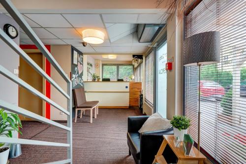 an office corridor with a couch and a desk at Smart2Stay Magnolia in Warsaw