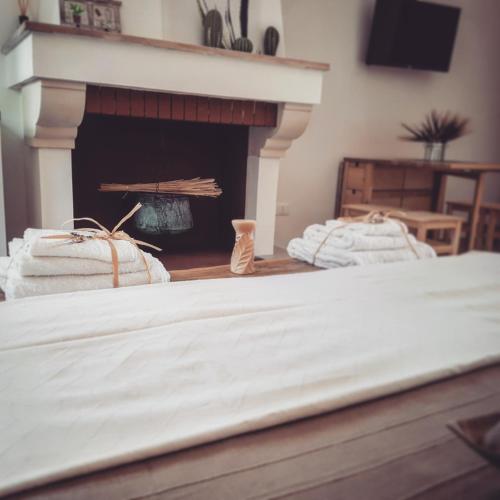 two beds in a room with a fireplace at Tenuta Guarascio in Cavallino di Lecce