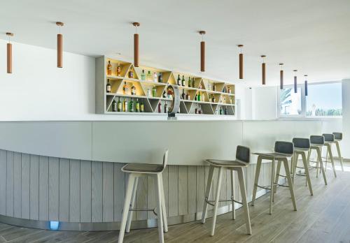 a row of stools at a bar in a restaurant at MH Atlantico in Peniche