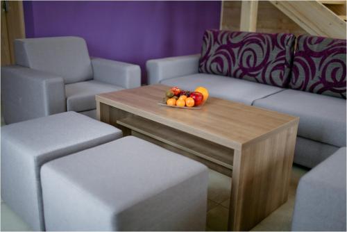 a table with a bowl of fruit on top of it at Rado Resort Spa & Wellness in Mielec