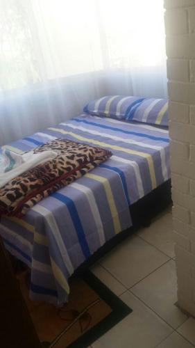 two beds sitting next to each other in a room at Rosebank Accommodation in Johannesburg