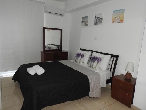 a bedroom with a bed with two towels on it at One Bedroom aptm Larnaca in Larnaka