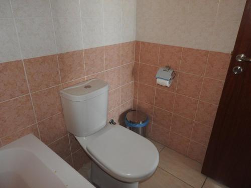 a bathroom with a toilet and a roll of toilet paper at One Bedroom aptm Larnaca in Larnaka