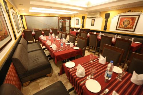 a dining room with long tables and chairs at Hotel City Heart Premium in Chandīgarh