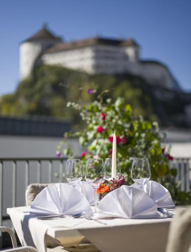 a table with wine glasses and a candle on it at Hotel Andreas Hofer in Kufstein