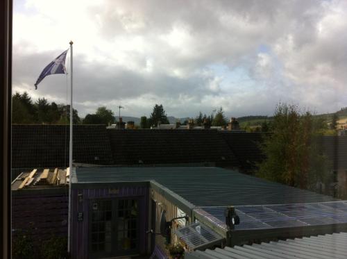 a flag on top of a building with a roof at The Whitehouse in Dingwall