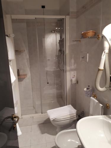 a bathroom with a shower and a toilet and a sink at Manuelina Taste Hotel in Recco