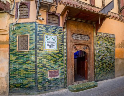 a building covered in mosaic tiles with a sign on it at Riad Hiba in Meknès