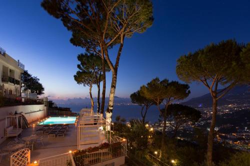 a pool with a view of the city at night at Residence Le Terrazze in Sorrento