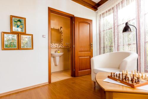a living room with a chess board on a table at Pštrossova Vila - u klášterní zahrady in Bechyně