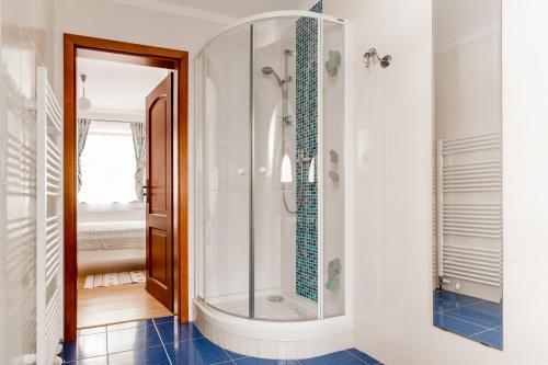 a shower with a glass door in a bathroom at Pštrossova Vila - u klášterní zahrady in Bechyně