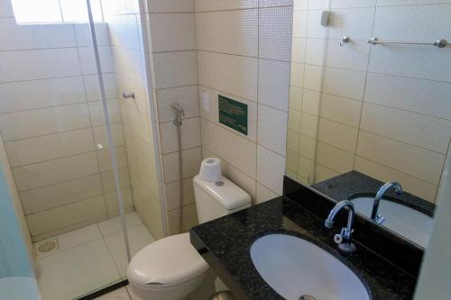 a bathroom with a sink and a toilet and a shower at Velit Hotel in Teresina