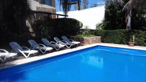 a group of chairs sitting next to a swimming pool at Paraiso Colon in Colón