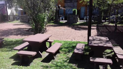 a picnic table and benches in a park at Paraiso Colon in Colón