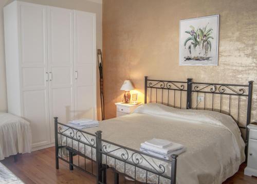 a bedroom with a bed and a lamp and a window at B&B Villa al Lago in Farra dʼAlpago