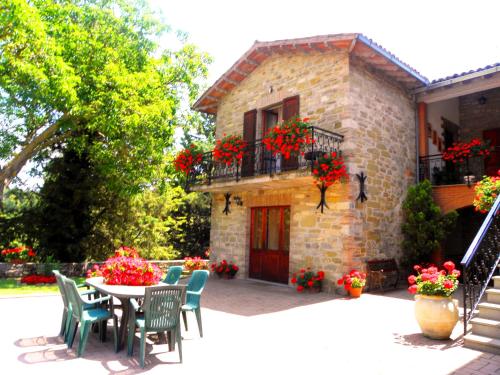 a patio with a table and chairs in front of a building at Aurora in Gubbio