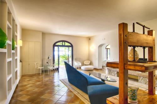 sala de estar con sofá azul y mesa en Villa Caprile en Massa Lubrense