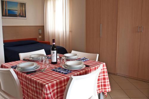 a table with a red and white checkered table cloth at Residence Borgomare in Albenga