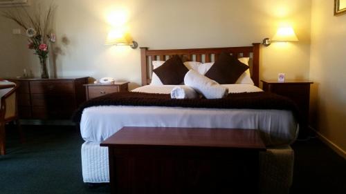 a hotel room with a large bed with two pillows at Ringwood Lake Inn in Ringwood