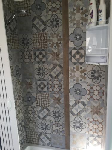a bathroom with a shower with a tiled floor at Chic & Beauty in Agrigento