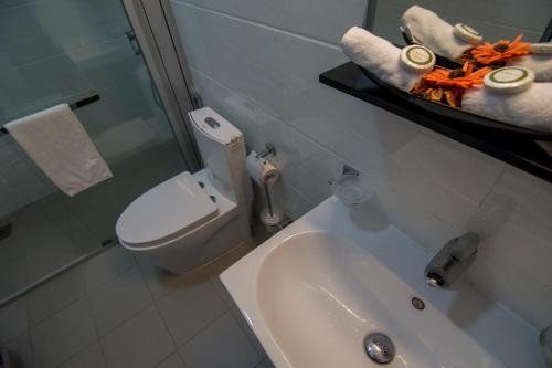 a bathroom with a toilet and a sink and a shower at Sea View Luxury Apartment, Fully Furnished, 2 Bedrooms, 2 Bathrooms in Mount Lavinia