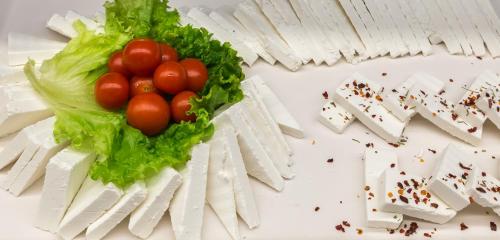 a bunch of tomatoes in lettuce next to a pile of playing cards at Acharavi Beach Hotel in Acharavi
