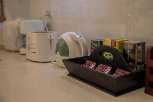 a black box on a counter with books and a toaster at Sea View Luxury Apartment, Fully Furnished, 2 Bedrooms, 2 Bathrooms in Mount Lavinia