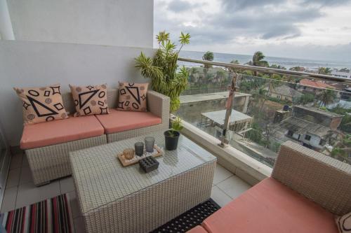 a balcony with a couch and a table with a view at Sea View Luxury Apartment, Fully Furnished, 2 Bedrooms, 2 Bathrooms in Mount Lavinia