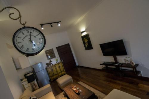 a living room with a large clock hanging on the wall at Sea View Luxury Apartment, Fully Furnished, 2 Bedrooms, 2 Bathrooms in Mount Lavinia
