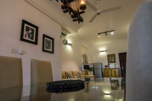 a dining room and living room with a glass table at Sea View Luxury Apartment, Fully Furnished, 2 Bedrooms, 2 Bathrooms in Mount Lavinia