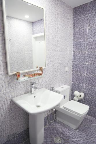 a bathroom with a sink and a toilet and a mirror at Two Seasons Boutique Hotel Baku in Baku