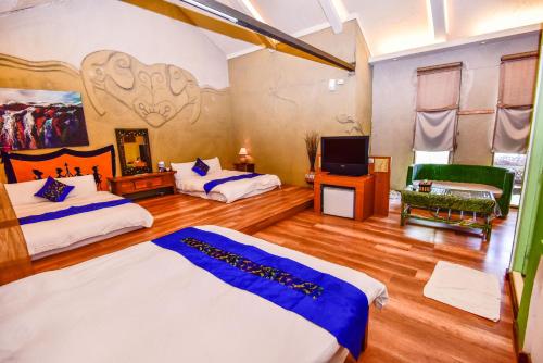 a room with two beds and a tv in it at Pancala Vacation Inn in Nanwan