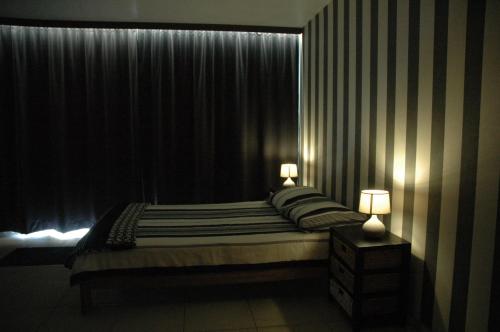 - une chambre avec un lit, deux lampes et une fenêtre dans l'établissement Studio De Zunneblomme, à Middelkerke