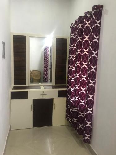 a bathroom with a mirror and a sink in a room at Munroe Heritage Inn in Munroe Island