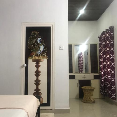a room with a bed and a lamp and a mirror at Munroe Heritage Inn in Munroe Island
