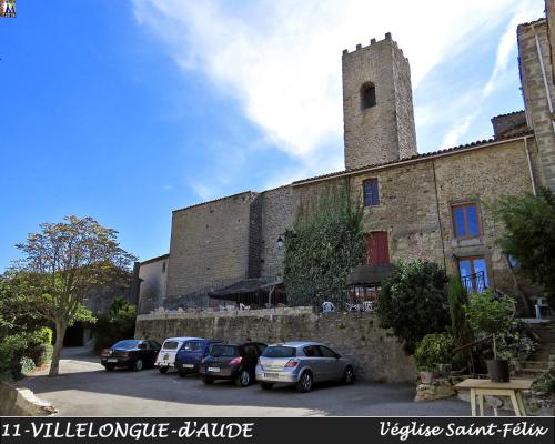 a large stone building with cars parked in a parking lot at Au Château de Villelongue B&B in Villelongue-dʼAude