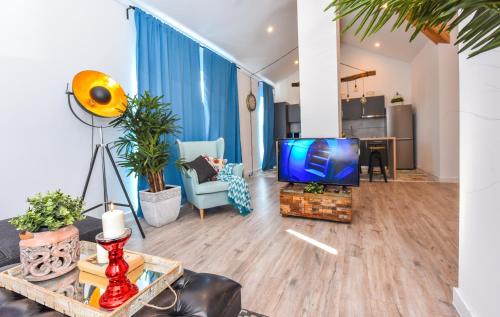 a living room with a flat screen tv and a couch at Parliament & River View Apartments in Bucharest