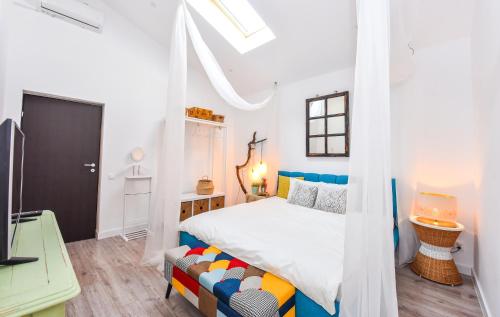 a white bedroom with a bed and a couch at Parliament & River View Apartments in Bucharest