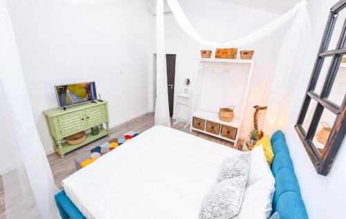 a small bedroom with a bed and a tv at Parliament & River View Apartments in Bucharest