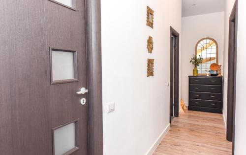 a hallway with a brown door and a dresser at Parliament & River View Apartments in Bucharest