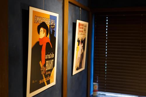two posters of a woman on a wall at Copain Kurumi in Kanazawa