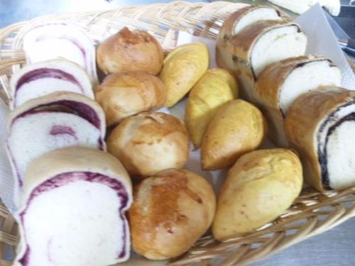 a basket of different types of pastries and bread at Pension Come in Minami Uonuma